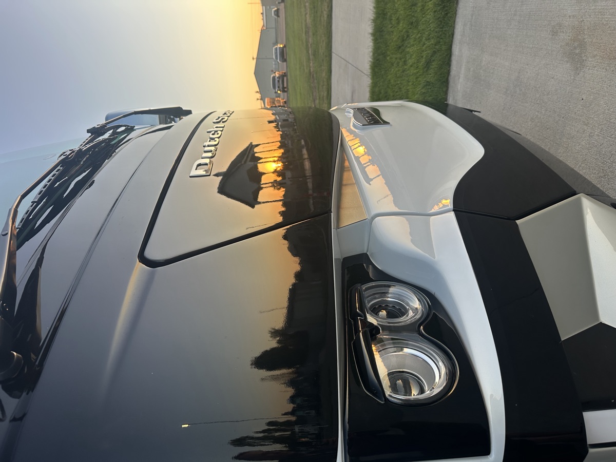 Spot-free mirror finish on a luxury motorhome at sunset