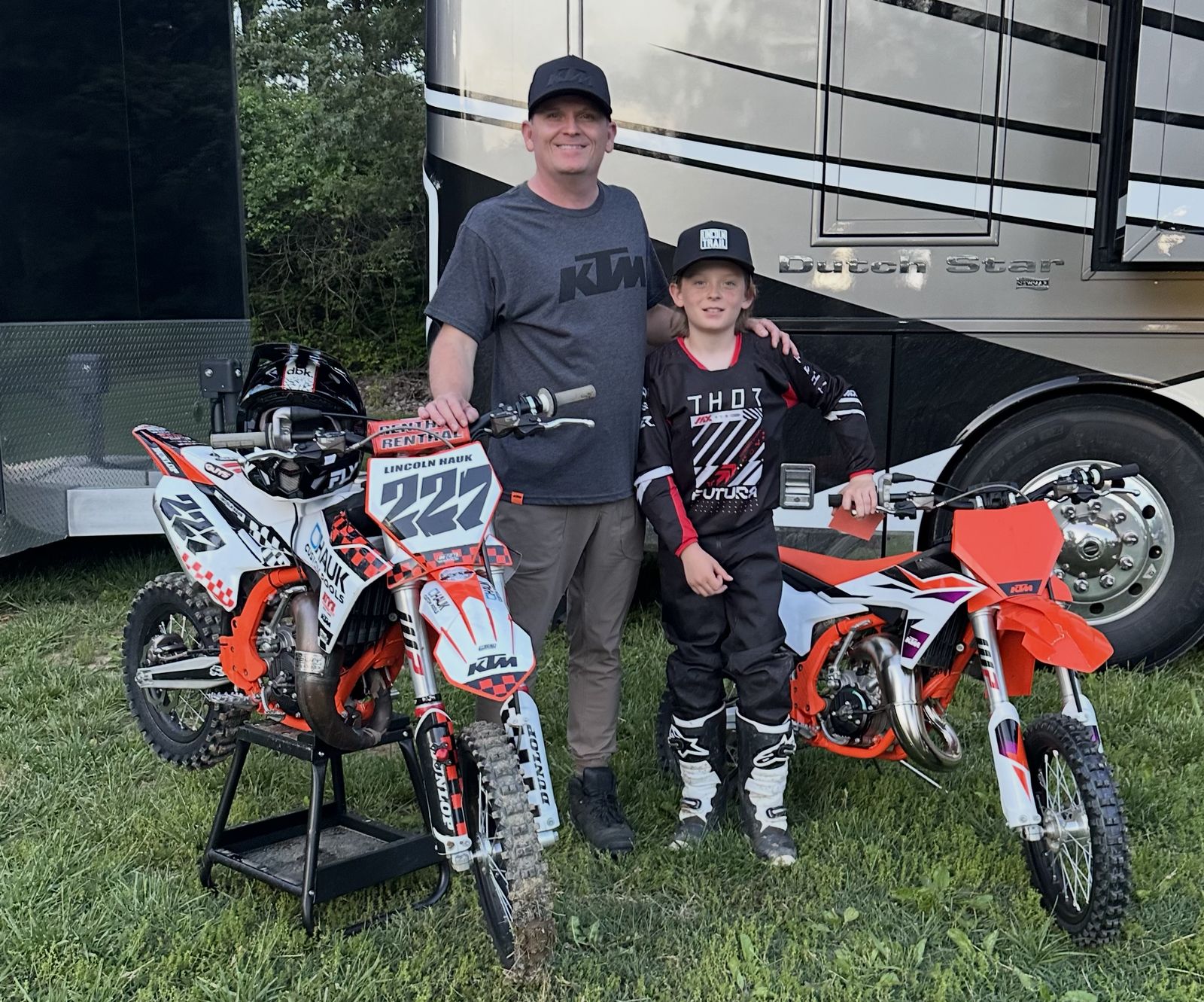 Jason Hauk, founder of H2O Simplified, with his son and their KTM motocross bikes in front of a Newmar Dutch Star motorhome
